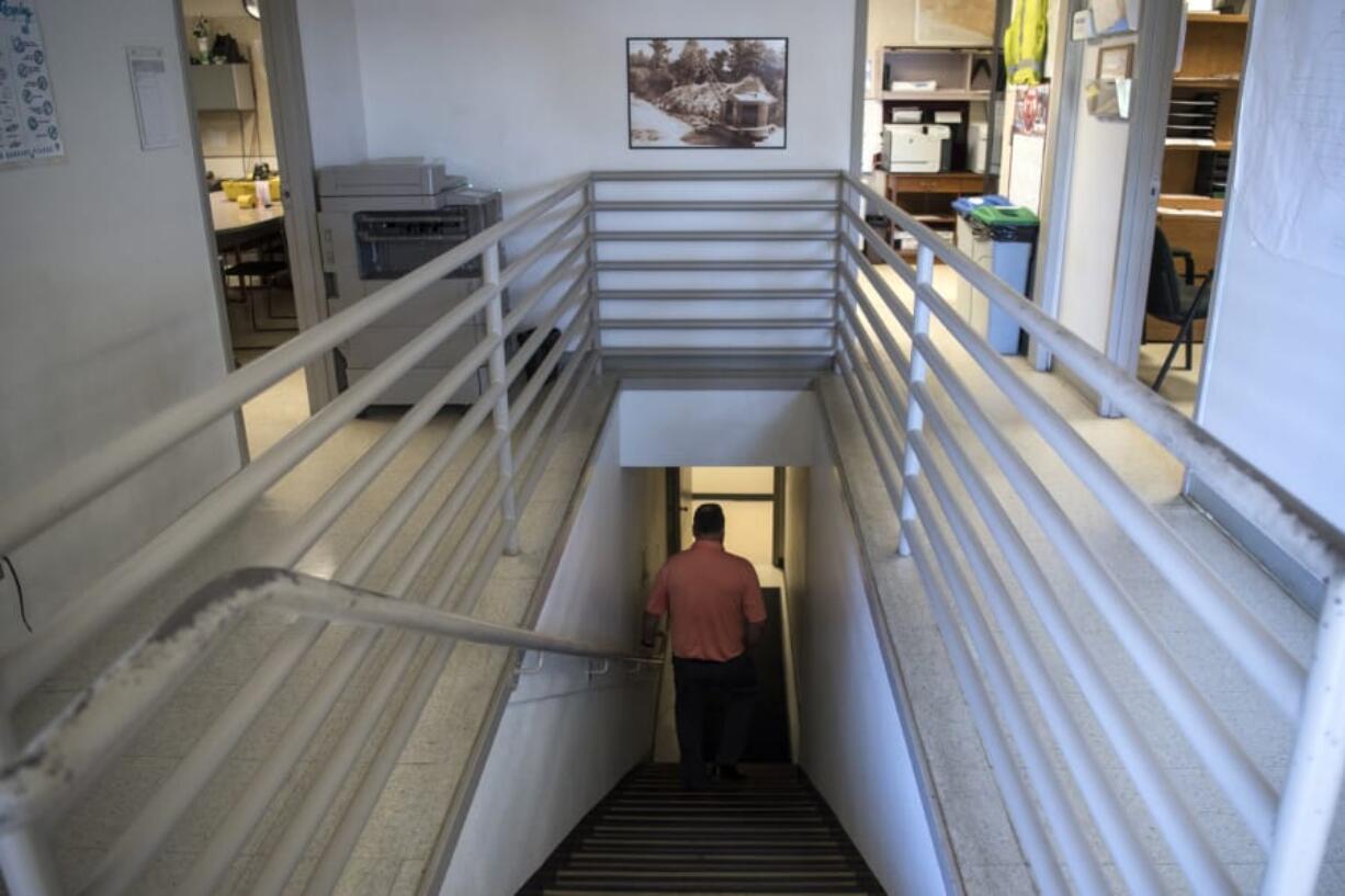 Operations Manager Tim Buck walks downstairs from the second floor offices at the Vancouver Operations Center. Most of the first floor, and all of the second floor of the building is only accessible by stairs and does not meet ADA standards.