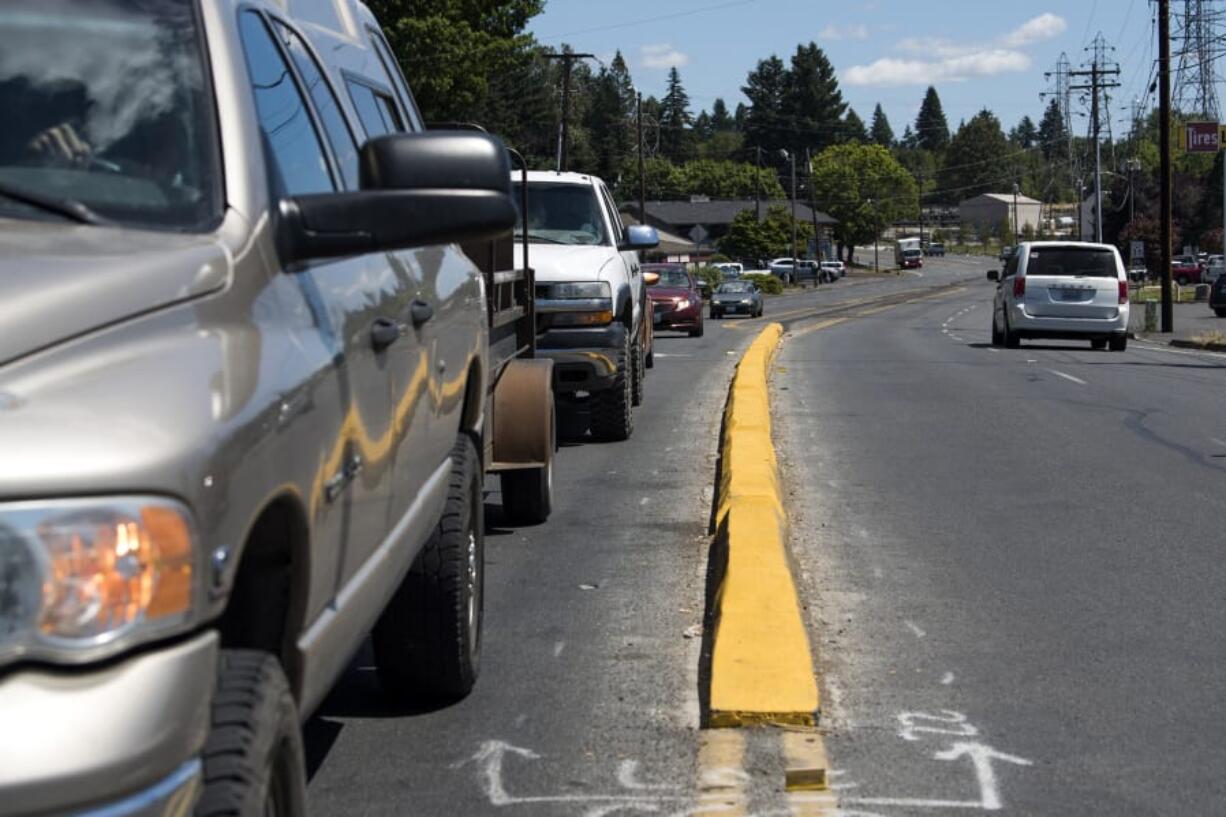 A recently installed median on Northeast Minnehaha Street stands out with its fresh coat of paint. But farther down the line, there’s a black mark where portions of it were removed after business owners complained.