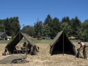 Corky Porter of Salem, Ore., left, and Jordan Stray of Tumwater set up their camps Friday at the World War II living history encampment put on by Living History Group Northwest and hosted by the National Park Service at Fort Vancouver National Historic Site.