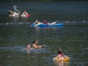 Swimmers and fishermen escape the summer heat at Battle Ground Lake State Park on Monday.