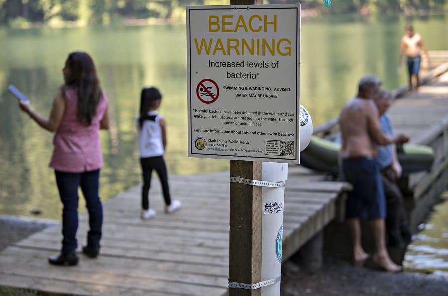 A sign at Battle Ground Lake State Park warns visitors of the possibility of increased levels of bacteria in the water in July 2018. Tests over the weekend showed no sign of the bacteria, and heath officials say signs will be removed if follow-up tests Monday verify that result.