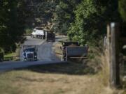 A trio of trucks travel to and from the Zimmerly gravel pit near Washougal.