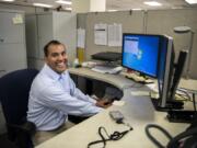 Compliance specialist and Paralympic gold medalist Aaron Paulson is pictured at his office at the Bonneville Power Administration’s Ross Complex in Vancouver on Thursday. Paulson recently won the BPA’s Administrator´s Award for Achievement in Equal Opportunity Employment or Diversity for his efforts in rekindling a disability awareness group. He contracted polio, which damaged nerves in his legs, when he was a 6-month-old baby in Bombay, India.