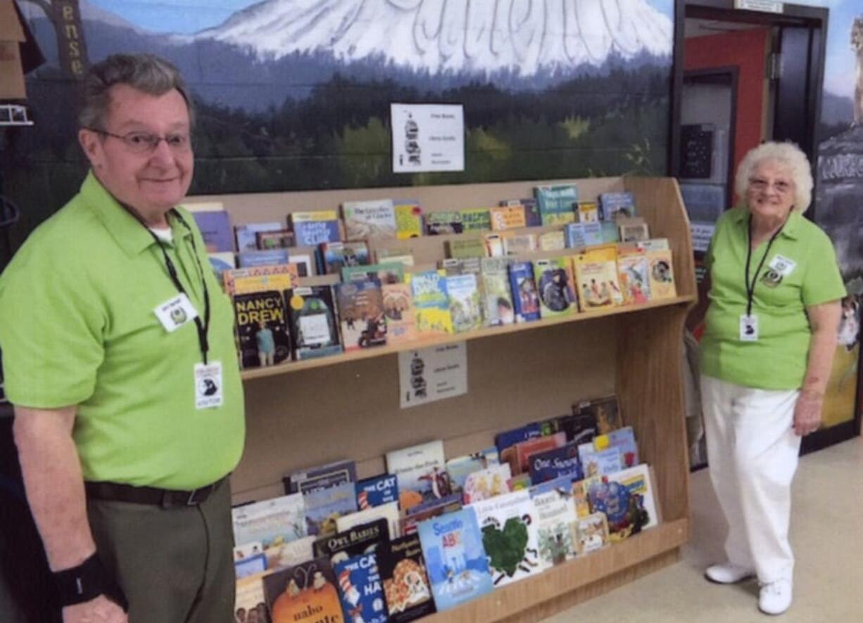 Fircrest: Orchard Evergreen Lions Club Director Jim Terrell, left, and Mary Jarson, secretary of the club, at Fircrest Elementary School’s lending library. The club donated books to the library and adopted the school as one of their community service projects.