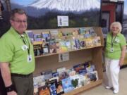 Fircrest: Orchard Evergreen Lions Club Director Jim Terrell, left, and Mary Jarson, secretary of the club, at Fircrest Elementary School’s lending library. The club donated books to the library and adopted the school as one of their community service projects.