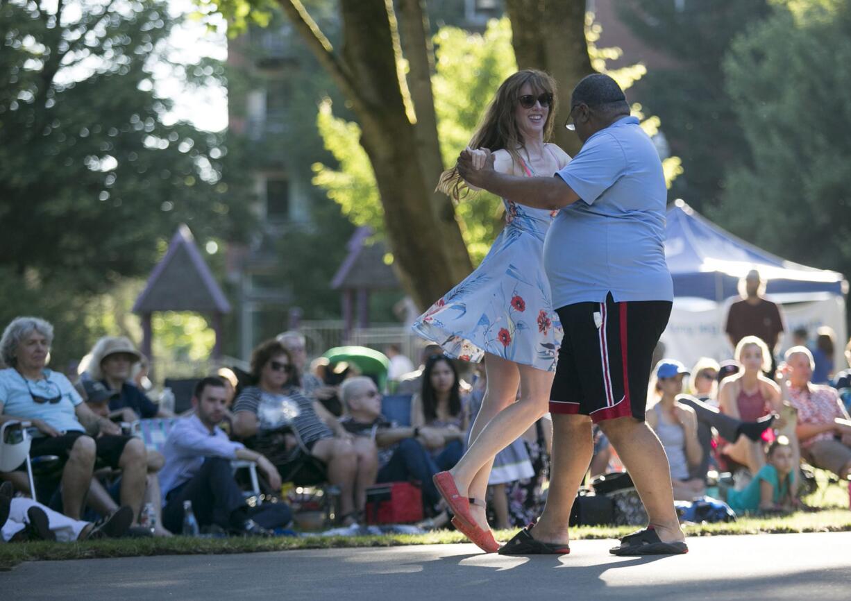 Pamela Gandarillas dances with Ralph Stevens as they enjoy the Vancouver Symphony Orchestra in Esther Short Park in downtown Vancouver on Thursday.