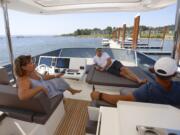 Jennifer Heredia, from left, Tim Hazen and Marcelo Heredia take a detour from the boats on offer for mere mortals to check out one of the multimillion-dollar luxury yachts on display at Tidewater Cove Boat Show Sunday.