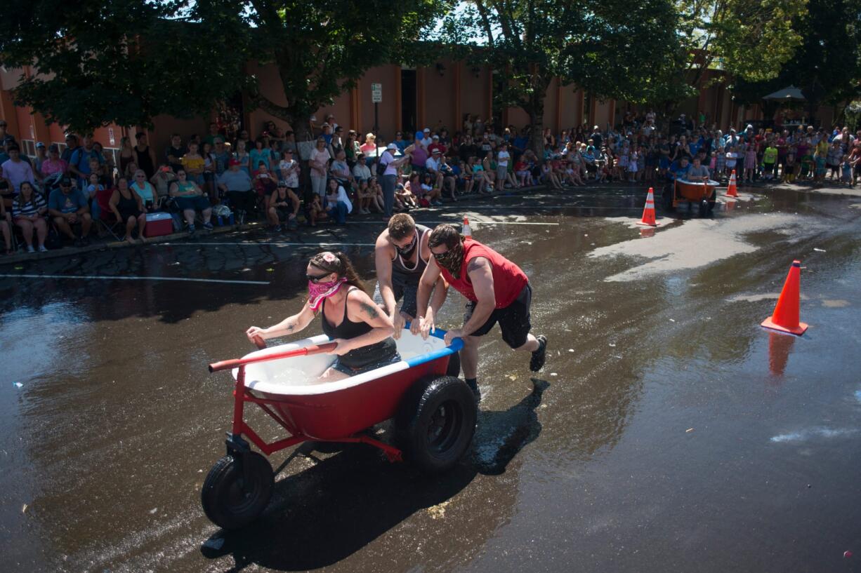 The Bathtub Bandits, steered by Tanya Groth and pushed by Tristian Groth and Greg Irwin, win a heat by a large margin during the Camas Days bathtub races on Saturday. The Bathtub Bandits won first place overall for the second year in a row.