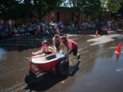 The Bathtub Bandits, steered by Tanya Groth and pushed by Tristian Groth and Greg Irwin, win a heat by a large margin during the Camas Days bathtub races on Saturday. The Bathtub Bandits won first place overall for the second year in a row.