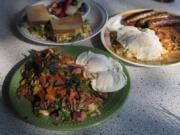 Corned beef hash, clockwise from foreground, is served with Bailey’s sandwich and the Ideal Breakfast with sausage at Natalia’s Cafe in Camas.