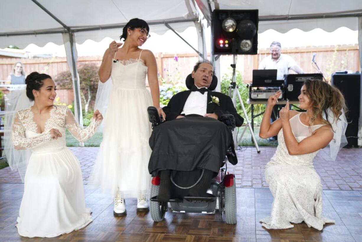 Akhil Jhaveri, 52, center, watches as his three daughters, Jordan Jhaveri, 18, from left, Ashley Jhaveri, 24, and Corinne Jhaveri, 23, dance around their father during a ceremonial wedding at Vintage Gardens in Ridgefield. The daughters choreographed a special dance for their dad and picked dresses unique to their personalities. At top, Laura Jhaveri shares a moment with her husband, Akhil Jhaveri, following the honorary wedding ceremony for their daughters. for their three daughters at Vintage Gardens in Ridgefield. Akhil is in the final weeks of his battle with ALS, or Lou Gehrig’s Disease, and he communicated to his wife that he wanted to see his daughters married before he died. The Jhaveri’s planned an honorary wedding for all three daughters with close family and friends in attendance.