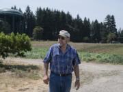 Joe’s Place Farms owner Joseph Beaudoin stands near land that he is selling to Ginn Development, which plans a subdivision of homes priced less than the county’s median.