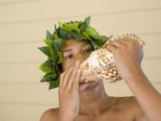 Nikon Brown of Tacoma, who performs with his family’s band, Te Manaia, blows the conch during the 2016 Three Days of Aloha festival in Esther Short Park.