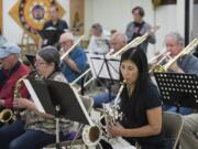 Elaine Yuzuriha plays the baritone saxophone during the Minidoka Swing Band’s rehearsal at the Oregon Buddhist Temple in Portland on June 24. The group worked on a new song, “Minidoka Swing Band,” written by Richard March and arranged by Kokichi Tagaw. It includes the lyrics: “Saturday night ’neath the Idaho moon, the Matsunaga boys were a-wailin’ a tune.