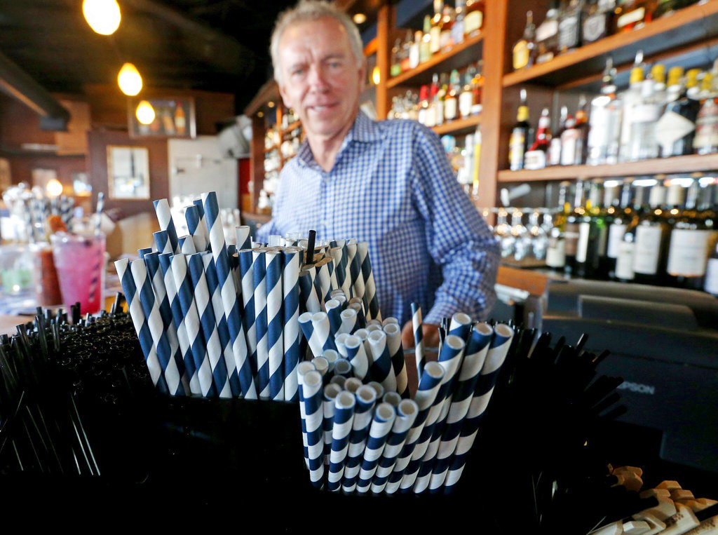 In this June 19, 2018 photo, paper straws sit at Duke Moscrip, owner of Duke's Restaurants, bar at his restaurant in Seattle. Businesses that sell food or drinks won’t be allowed to offer the plastic items under a rule that went into effect Sunday, July 1.