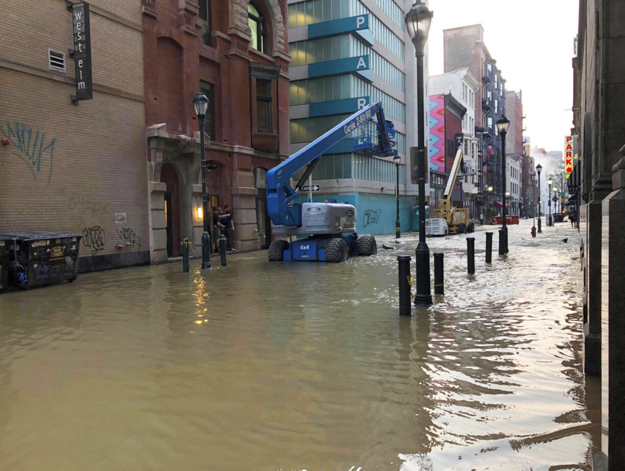 Water covers a street after a water main broke in Philadelphia on Tuesday morning July 3, 2018. The break happened before 4 a.m. Tuesday, and a number of center city streets have been closed.