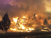 In this photo released Friday, July 6, 2018, by the California Highway Patrol, the Klamathon Fire burns in Hornbrook, Calif. A local California official says a deadly blaze burning near the Oregon border moved swiftly through the rural area that is home to many retirees. Siskiyou County Board of Supervisors chair Ray Haupt says the blaze moved so fast it quickly reached Hornbrook, a community of about 250 people about 14 miles (22 kilometers) south of the Oregon border. Authorities said one person was killed in the fire.