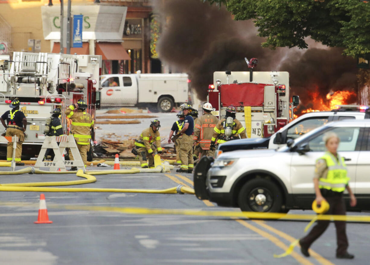 Authorities work the scene of an explosion in downtown Sun Prairie, Wis., Tuesday, July 10, 2018. The explosion rocked the downtown area of Sun Prairie, a suburb of Madison, after a contractor struck a natural gas main Monday, sending an unknown number of people to hospitals, authorities said.