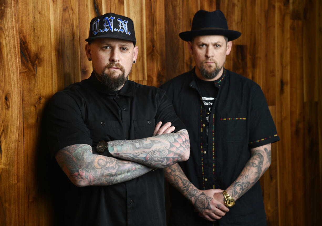 In this Tuesday, July 10, 2018, photo, Benji Madden, left, and his twin brother Joel Madden of the band Good Charlotte pose for a portrait, in Burbank, Calif. The city of Annapolis, Md. will hold a benefit concert on July 28 featuring the Maryland-based band to honor the five Capital Gazette employees killed in an attack in their newsroom.