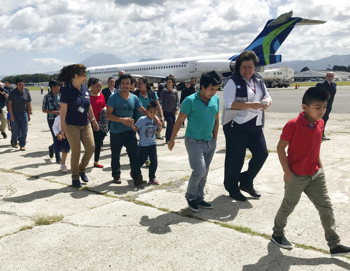 Families separated under President Donald Trump administration’s zero tolerance policy return home to Guatemala City, Guatemala, Tuesday, July 10, 2018, after being deported from the United States. After lining up on the tarmac, they headed to a processing center where they were screened and given identification before being released back into the country.