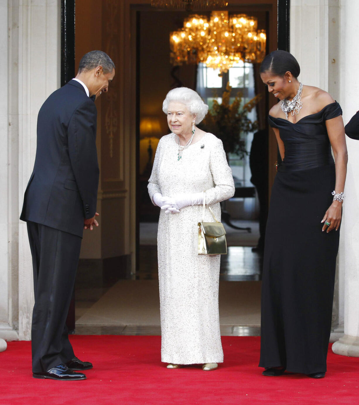 FILE  -  In this Wednesday, May 25, 2011 file photo, US President Barack Obama and first lady Michelle Obama welcome Britain's Queen Elizabeth II for a reciprocal dinner at Winfield House in London. US President Trump enjoys flouting diplomatic rules and expressing himself in bold and sometimes mocking tweets and comments, but that side of his personality is unlikely to surface when he takes tea Friday, July 13, 2018 with Queen Elizabeth II. The president and his wife Melania are not expected to make waves during the visit with the 92-year-old monarch, who has met every U.S. president since Dwight Eisenhower with the exception of Lyndon Johnson, who never visited Britain while in office.