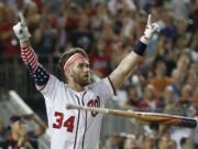 Washington Nationals Bryce Harper (34) reacts to his winning hit during the Major League Baseball Home Run Derby, Monday, July 16, 2018 in Washington.