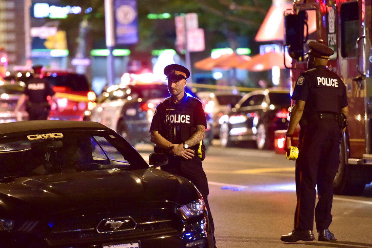 Police work the scene of a shooting in Toronto on Sunday, July 22, 2018.