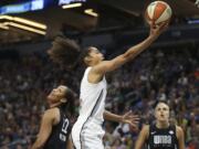 Team Candace Parker's Skylar Diggins-Smith, center, goes to the basket against Team Delle Donne's A'ja Wilson (22) in the first half of the WNBA All-Star basketball game Saturday, July 28, 2018 in Minneapolis.