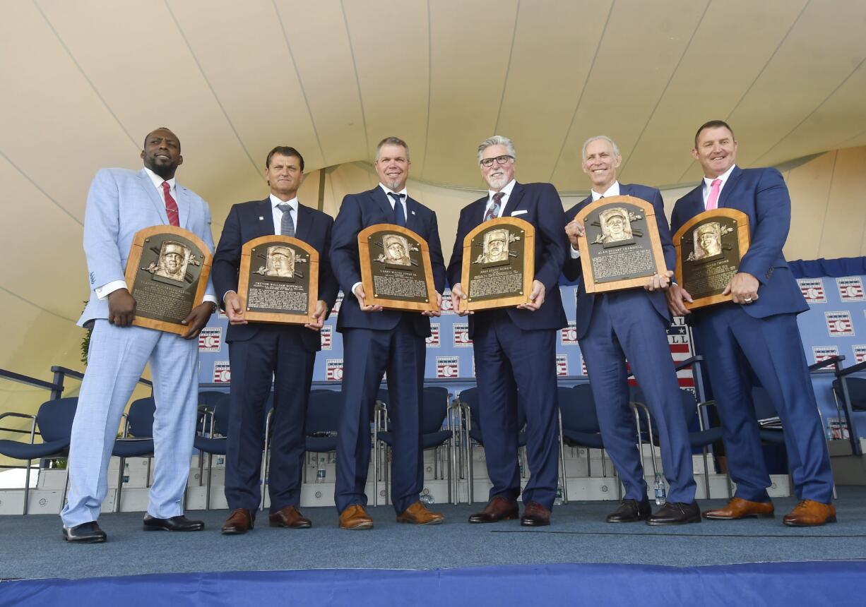 Baseball Hall of Famers from left, Vladimir Guerrero, Trevor Hoffman, Chipper Jones, Jack Morris, Alan Trammell, and Jim Thome, hold their plaques after an induction ceremony at the Clark Sports Center on Sunday, July 29, 2018, in Cooperstown, N.Y.