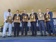 Baseball Hall of Famers from left, Vladimir Guerrero, Trevor Hoffman, Chipper Jones, Jack Morris, Alan Trammell, and Jim Thome, hold their plaques after an induction ceremony at the Clark Sports Center on Sunday, July 29, 2018, in Cooperstown, N.Y.