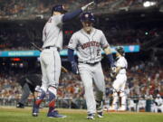 Houston Astros George Springer (4) congratulates Houston Astros Alex Bregman (2) on Bregman’s solo home run during the tenth inning at the Major League Baseball All-star Game, Tuesday, July 17, 2018 in Washington.