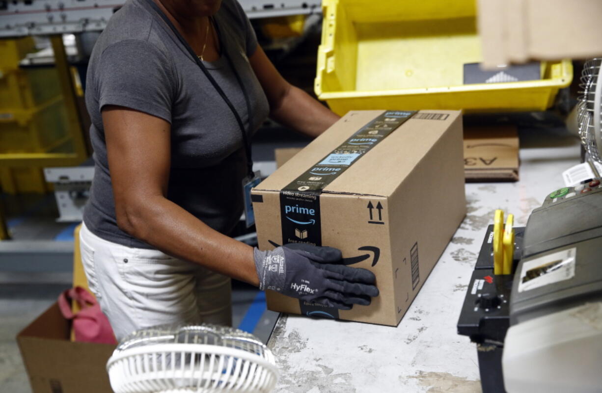 Myrtice Harris applies tape to a package before shipment at an Amazon fulfillment center in Baltimore. Amazon’s Prime Day starts July 16, 2018, and will be six hours longer than last year’s and will launch new products.