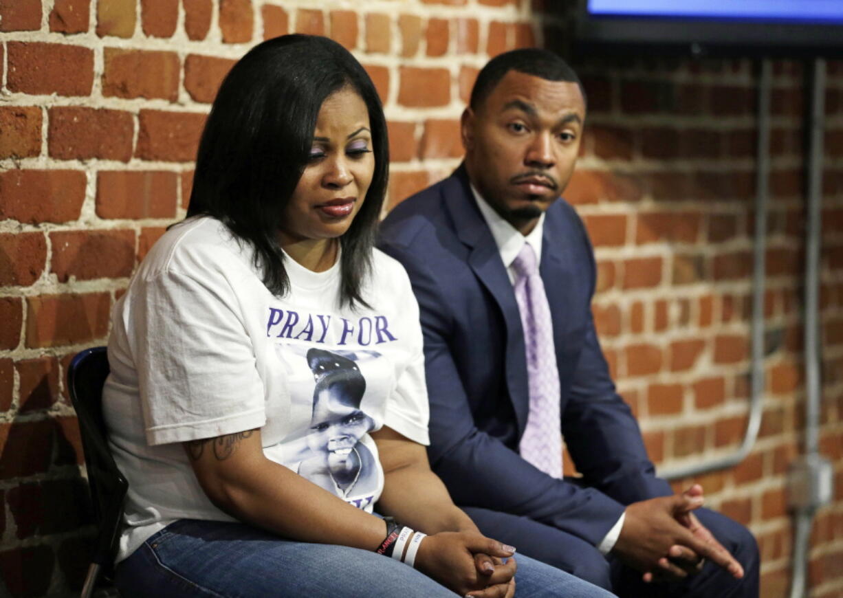 Nailah Winkfield, left, and Omari Sealey, right, the mother and uncle of Jahi McMath, listen to doctors speak during a news conference in San Francisco on Oct. 3, 2014. The mother of a girl at the center of a medical and religious debate over brain death says she does not regret selling her home and moving to New Jersey so her daughter could receive care after being declared dead. Nailah Winkfield said at a news conference on Tuesday that she gave up everything for her daughter Jahi McMath, but it was worthwhile. The San Francisco Chronicle reports that Jahi will be buried on Friday in Hayward, Calif.