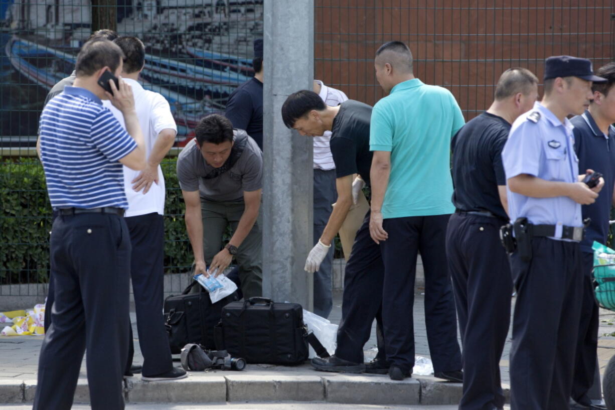 Chinese officials work near the site of a reported blast just south of the U.S. Embassy in Beijing on Thursday.