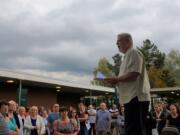 Doug Sheddy speaks to a crowd opposing the adoption of "High School FLASH" Monday at Battle Ground Public Schools. Critics of the curriculum say its lessons on gender identity and sexual orientation are not appropriate for children.