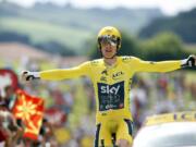 Britain's Geraint Thomas, wearing the overall leader's yellow jersey reacts as he crosses the finish line during the twentieth stage of the Tour de France cycling race, an individual time trial over 31 kilometers (19.3 miles) with start in Saint-Pee-sur-Nivelle and finish in Espelette, France, Saturday, July 28, 2018.