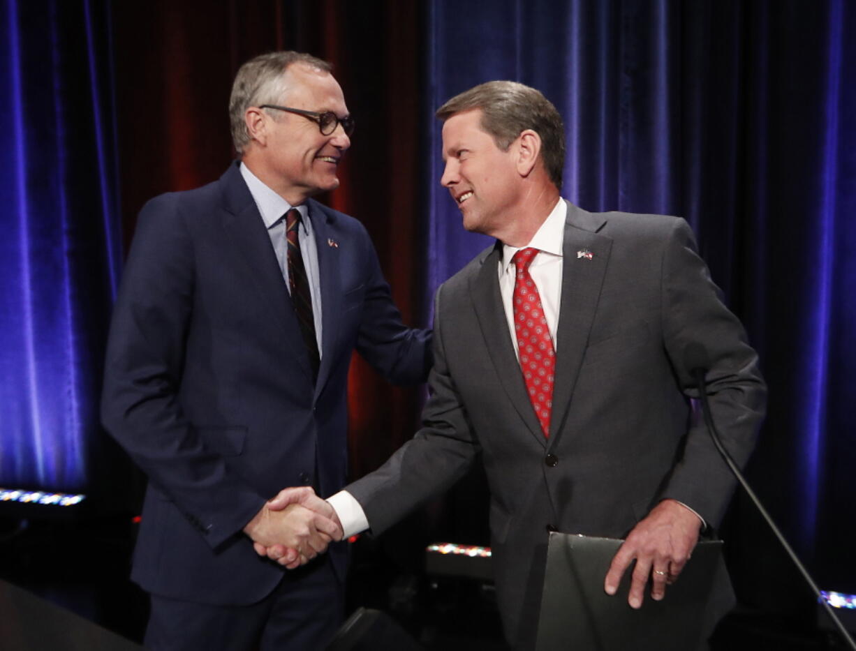 Georgia Republican gubernatorial candidates, Lt. Gov. Casey Cagle, left, and Secretary of State Brian Kemp shake hands after an Atlanta Press Club debate at Georgia Public Television in Atlanta. The two will face each other July 24 in a primary runoff for the Republican nomination.