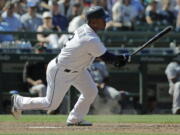 Seattle Mariners’ Jean Segura watches his tie-breaking RBI single during the eighth inning of a baseball game against the San Francisco Giants, Wednesday, July 25, 2018, in Seattle. The Mariners won 3-2. (AP Photo/Ted S.