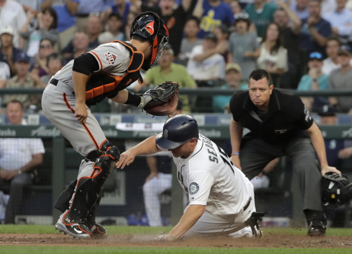 Seattle Mariners’ Kyle Seager is tagged out at home by San Francisco Giants catcher Buster Posey as he tried to score on a single by Mike Zunino during the fourth inning of a baseball game Tuesday, July 24, 2018, in Seattle. (AP Photo/Ted S.