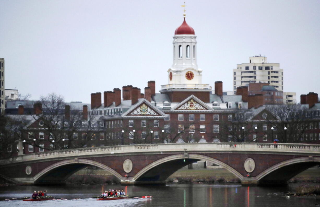 Rowers paddle along the Charles River past the Harvard College campus in Cambridge, Mass. A 2018 lawsuit alleging bias at Harvard’s admissions office is pulling back the curtain on the secretive, complex process that decides who gets a place at one of the world’s most selective institutions.