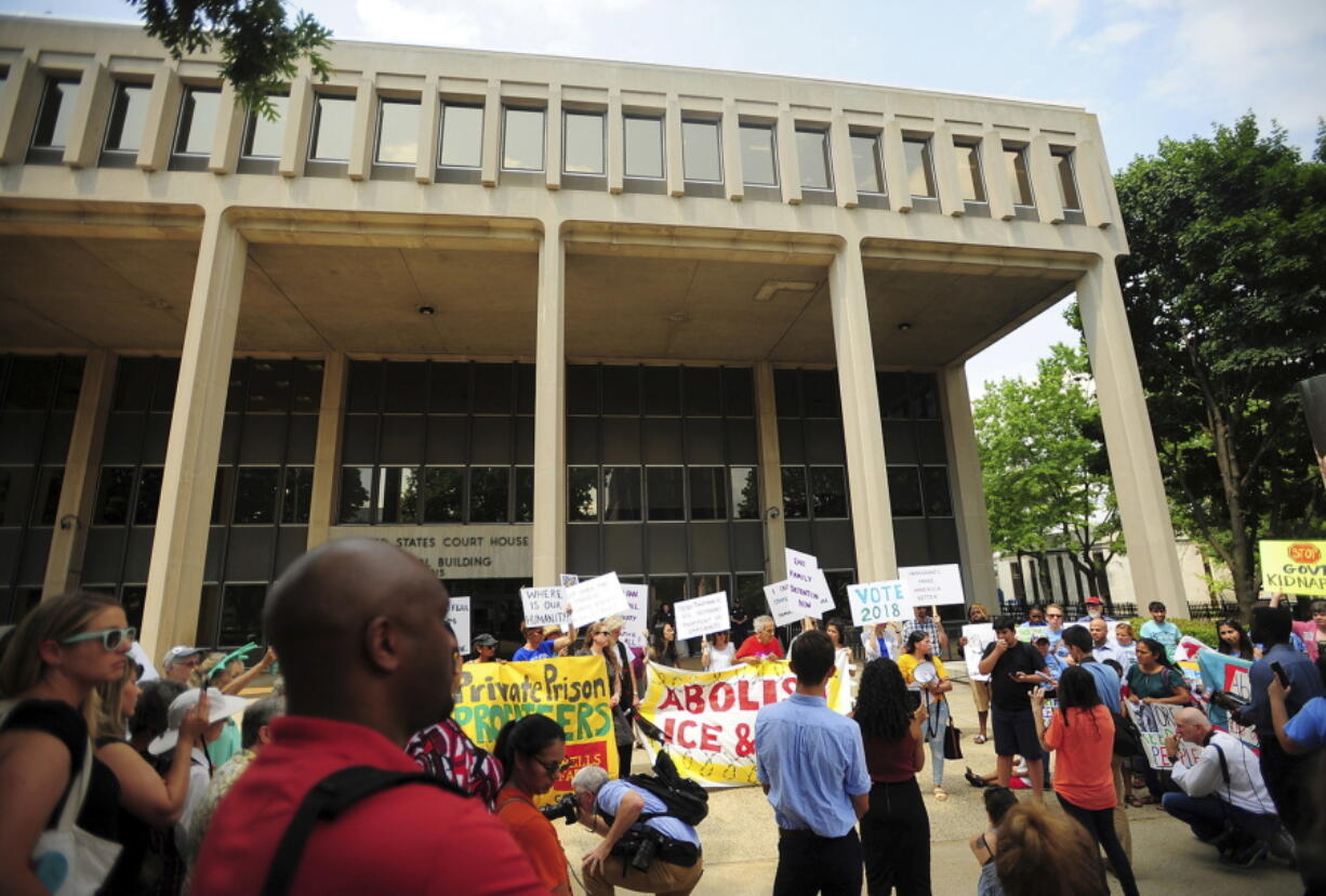 People hold a rally outside the Federal Courthouse in Bridgeport, Conn. on Wednesday, July 11, 2018. Lawyers for two immigrant children detained in Connecticut after being separated from their parents at the U.S.-Mexico border asked a federal judge on Wednesday to order that the girl and boy be reunited with their families. (Brian A.