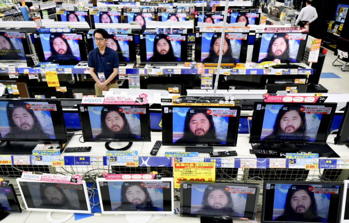 TV screens at an electrical appliance store show the image of doomsday cult leader Shoko Asahara in news reports, in Urayasu, near Tokyo, on Friday. Asahara and six followers were executed Friday for their roles in a deadly 1995 gas attack on the Tokyo subways and other crimes, Japan’s Justice Ministry said.