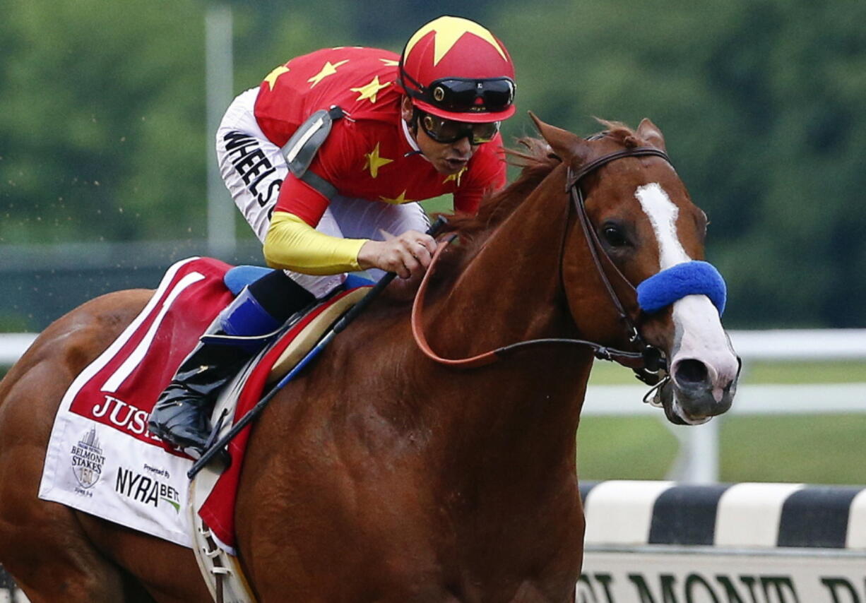 Justify, with jockey Mike Smith up, crosses the finish line to win the 150th running of the Belmont Stakes. The undefeated Triple Crown winner has been retired from racing because of fluid in his left front ankle, trainer Bob Baffert and Justify’s owners announced Wednesday, July 25, 2018.