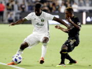 Portland Timbers forward Dairon Asprilla, left, pushes away Los Angeles FC forward Latif Blessing during the second half of an MLS soccer game in Los Angeles, Wednesday, July 18, 2018.