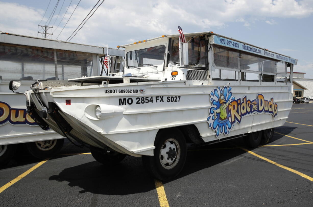 FILE - In this July 20, 2018, file photo, a duck boat sits idle in the parking lot of Ride the Ducks, an amphibious tour operator in Branson, Mo. A lawsuit seeking $100 million in damages was filed Sunday, July 29, against the owners and operators of a duck boat that sank July 19.