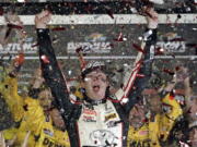 Erik Jones celebrates after winning the NASCAR Cup Series auto race at Daytona International Speedway.