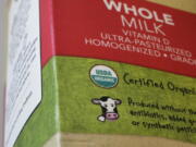 In this Monday, July 9, 2018 photo a “USDA Organic” label is printed on a milk carton in Walpole, Mass. The USDA Organic label generally signifies a product is made without synthetic pesticides and fertilizers, and that animals are raised according to certain standards. But disputes over the rules and reports of fraud may have some questioning whether the seal is worth the price.
