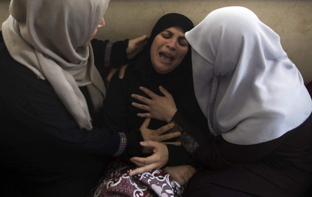 Relatives of 15-year-old Othman Hilles, mourn during his funeral in the family home in Gaza City, Saturday, July 14, 2018. Hilles was killed on Friday at a border protest by Israeli fire, Gaza’s Health Ministry said.