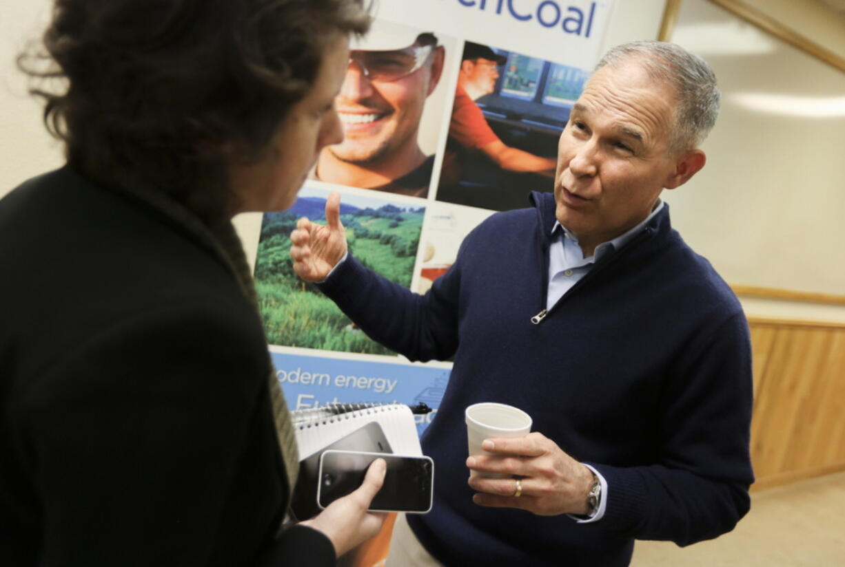 FILE- In this March 29, 2018, file photo, EPA Administrator Scott Pruitt talks with local media following a press conference after taking a tour of the Black Thunder coal mine outside of Wright, Wyo. Pruitt moved to roll back environmental regulations affecting many industries. Pruitt proposed last year to repeal a key climate-change regulation of President Barack Obama’s administration, which aimed to reduce emissions of carbon-trapping gases from coal-fired power plants.