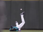 Seattle Mariners center fielder Guillermo Heredia cannot get to a two-run triple hit by Colorado Rockies’ Tony Wolters off relief pitcher Roenis Elias during the sixth inning of a baseball game Friday, July 6, 2018, in Seattle.